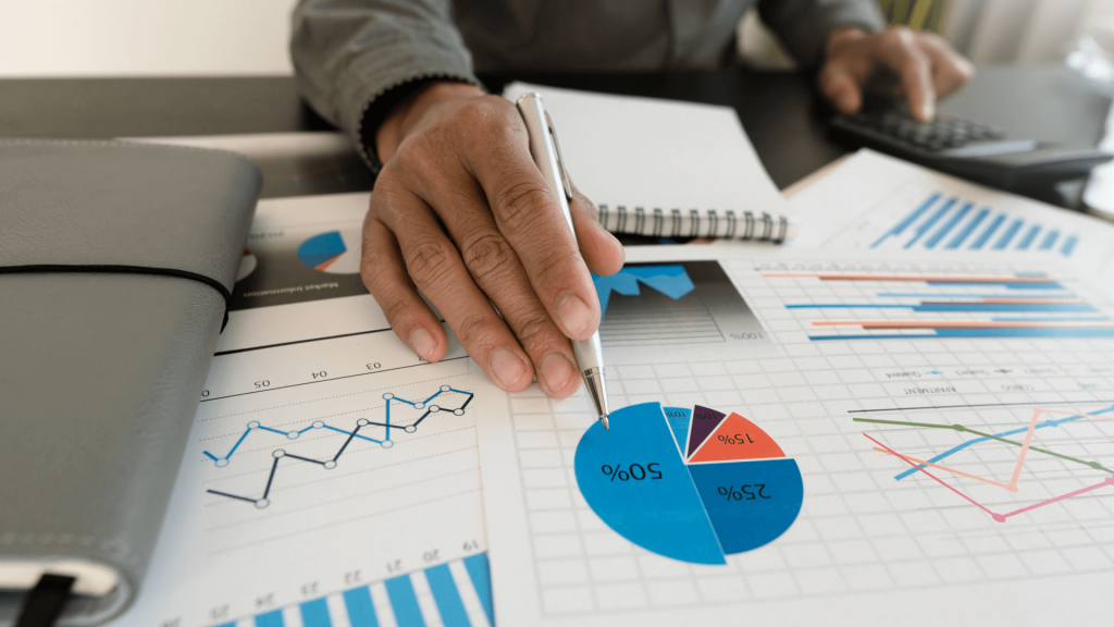 a businessman points at a pie chart with a pen