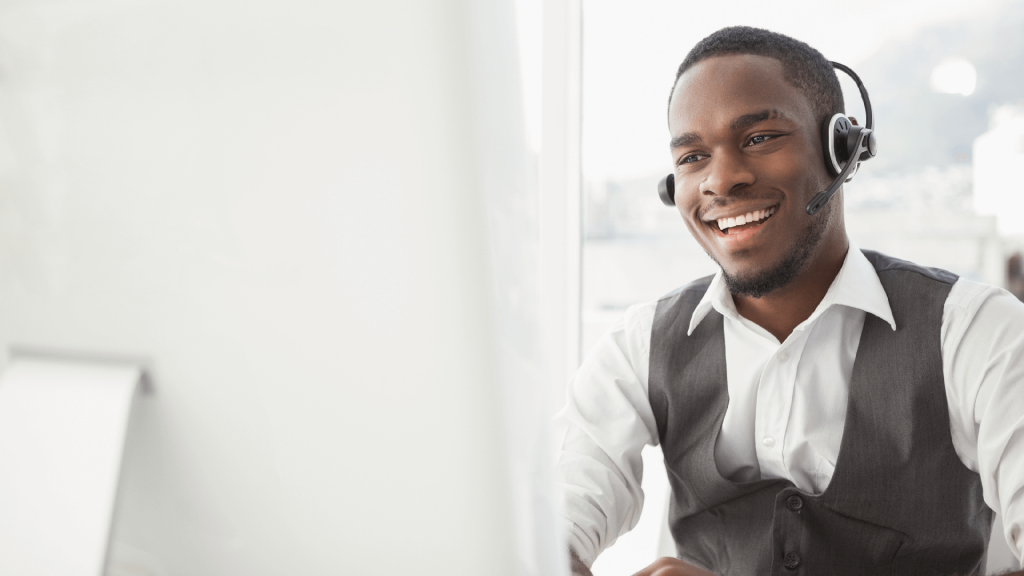 a smiling businessman talks on a headset