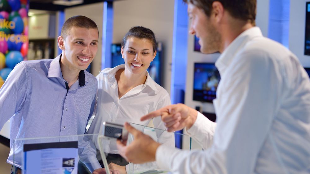Salesman talking to customers | Try LinkPoint360's Sales Enablement Tools | Linkpoint360