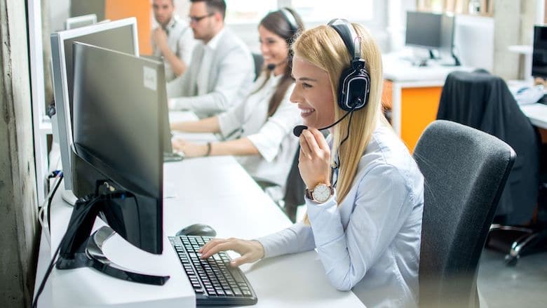 Saleswoman smiling while talking on headset | Sales Enablement | LinkPoint360