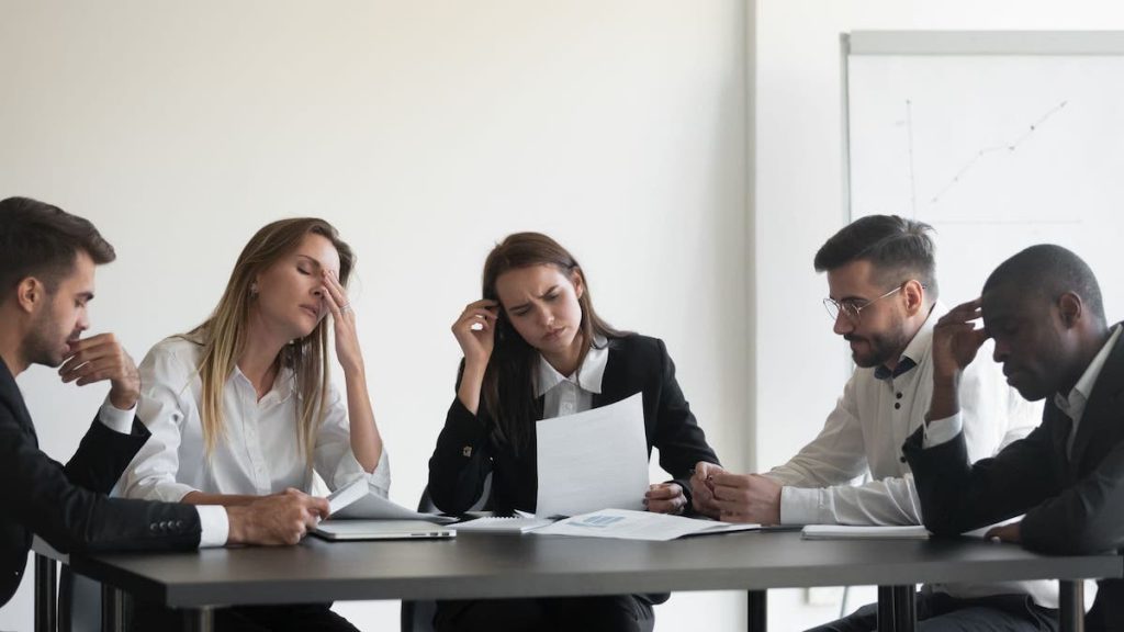 Frustrated sales team sitting together at a table | Linkpoint360