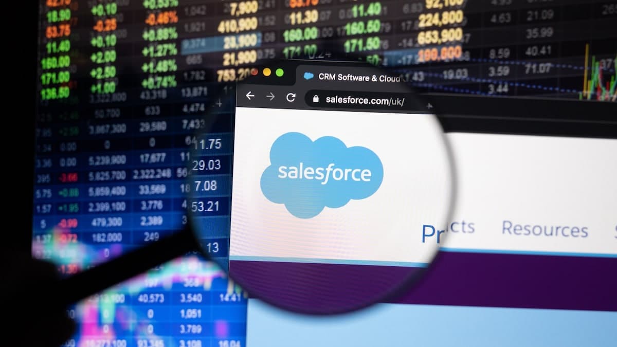 Person holding magnifying glass up to Salesforce CRM logo on computer screen | Linkpoint360