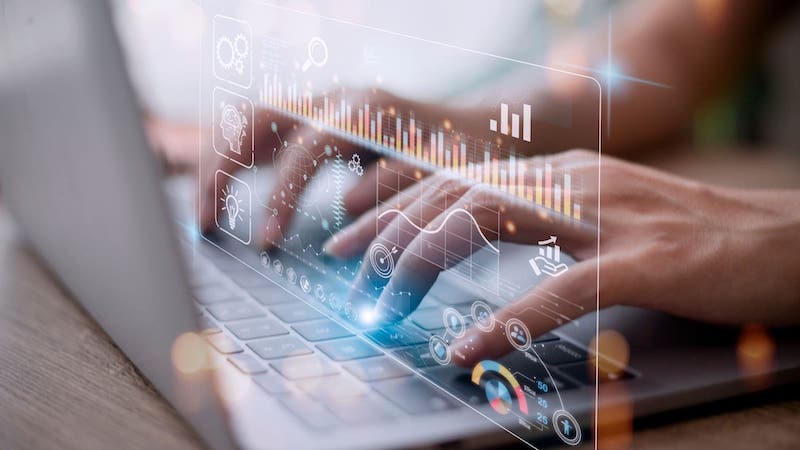 Analytics graph hovers over fingers as they type on laptop keyboard | Organizing customer data in a CRM