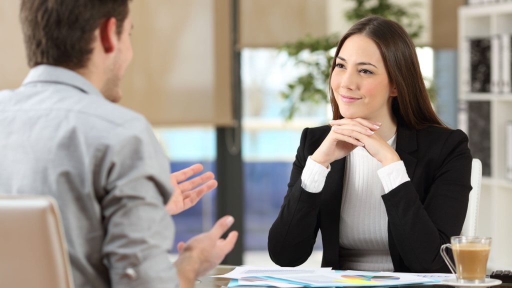 Woman Smiles While Talking to Salesman at Office Desk | AI and Salesforce