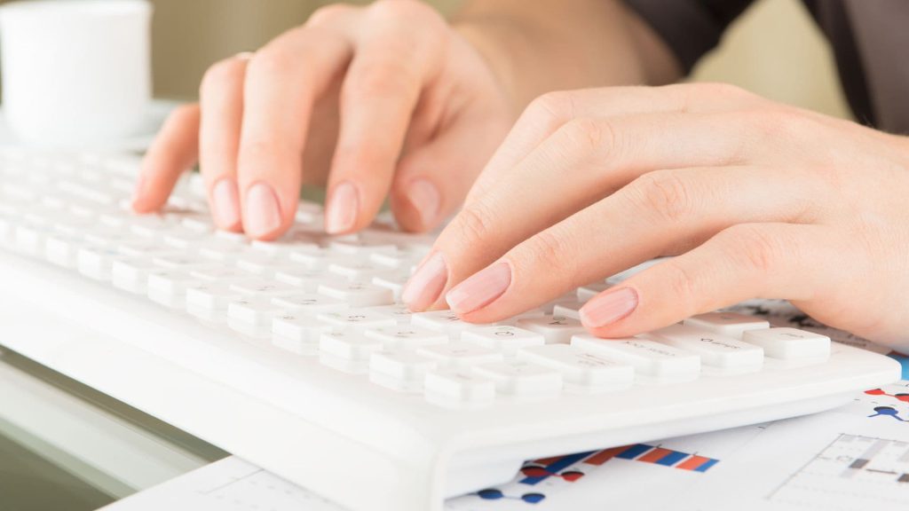 Close up of Salesperson Typing on White Keyboard | AI and Salesforce