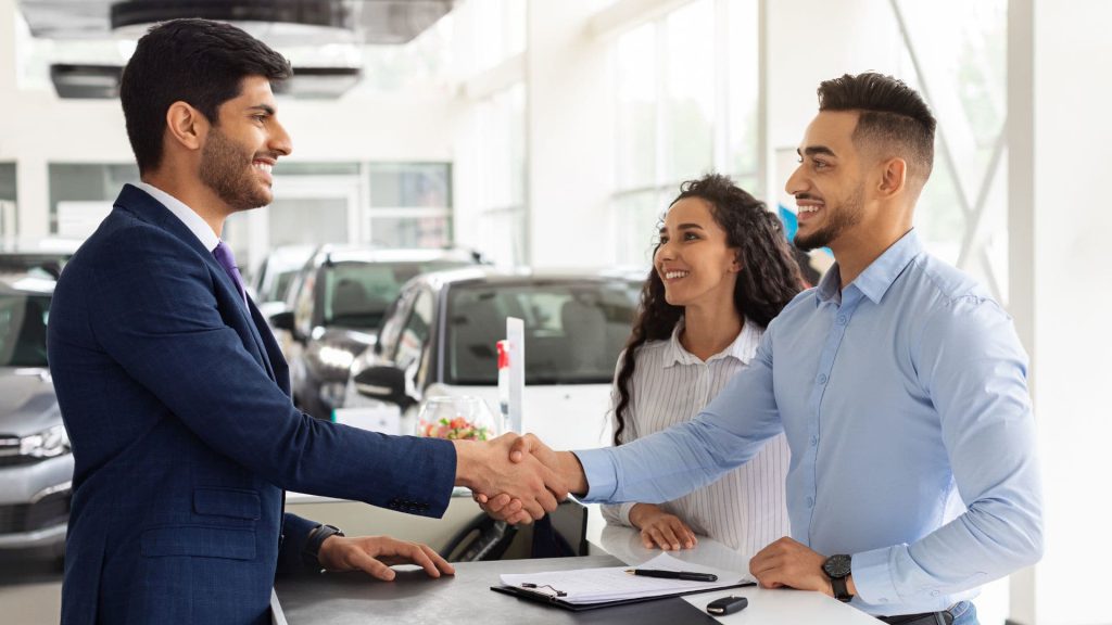 Couple Shakes Salesperson's Hand as They Close a Deal | How to Use Sales AI