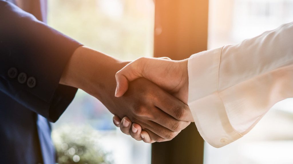 Close Up of Sales Managers Shaking Hands | What is CRM Integration?