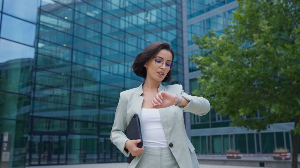 Saleswoman checks reminder on her smartwatch while walking to meeting | CRM tips and tricks