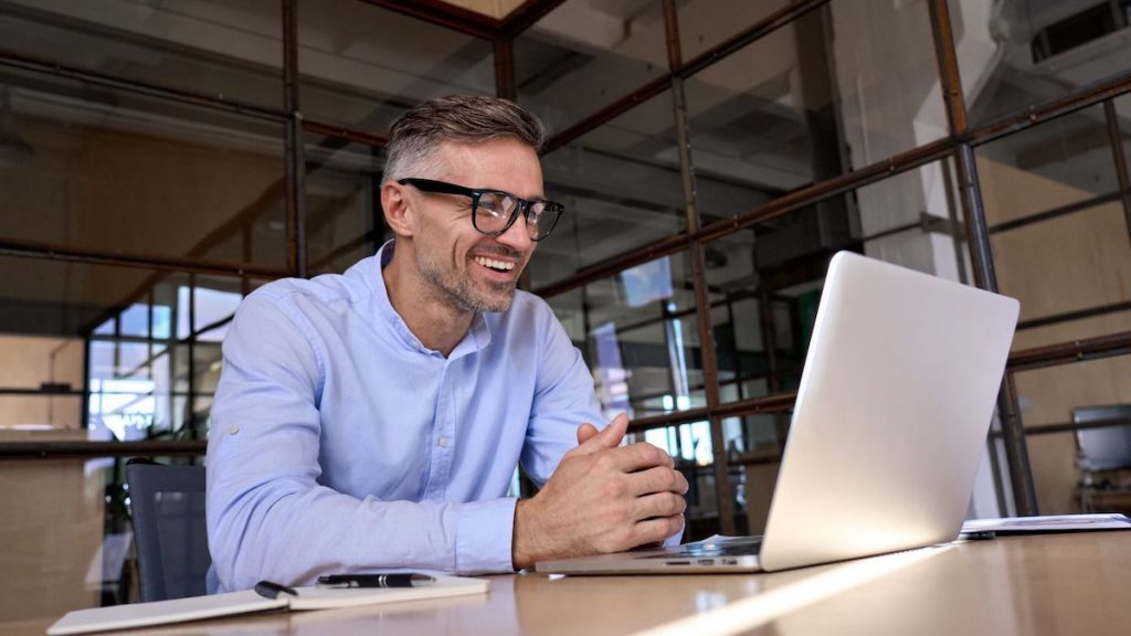 Sales manager smiles as he integrates LinkPoint360 with his CRM software | CRM tips and tricks