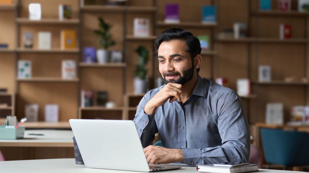 Salesperson holds chin as he contemplates the arrangement of Salesforce App Launcher | Top 10 Salesforce Tips