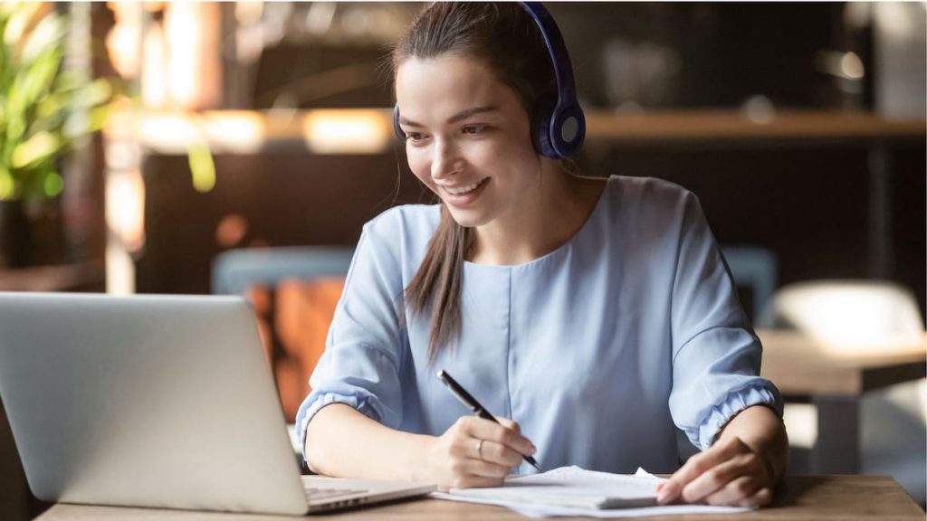 Salesforce user wearing headphones smiles during training | Top 10 Salesforce Tips
