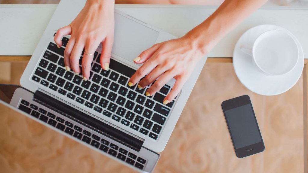 Aerial view of hands typing on laptop keyboard | Top 10 Salesforce Tips