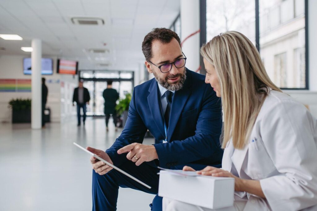 Sales rep reviewing data with an employee | What is CRM integration?